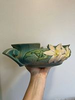 Side profile showing floral relief and handle of Roseville Clematis bowl