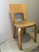 Front angled view of chair showing seat, legs and backrest