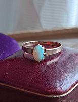 Front view of oval opal set in 9k gold band