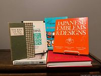 Front view of all six books standing and stacked