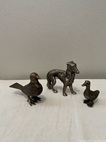 Front view of all three metal animal figurines