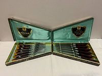 Open boxes showing full 12-piece cutlery set