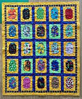 Full view of handmade quilt showing all 25 jar blocks and overall color scheme