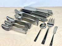Stacks of knives, forks, spoons, plus serving pieces