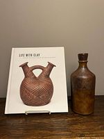 Bottle vase and hardcover book front view