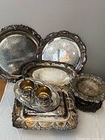 assorted silverplate pieces stacked together showing overall lot
