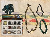 Overview of all beads, stones and packaged charms on textile background