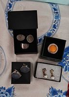 All five sets of jewellery pieces in boxes