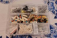 open plastic jewelry box showing assorted contents