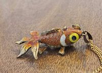 Side view of articulated enamel koi fish pendant on chain