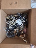 Box filled with assorted cables, connectors visible