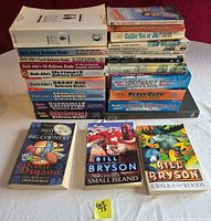 All books laid out in two background stacks plus three Bryson books in front