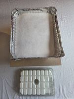 Tray holding white silica crystals and packaged white glycerin soap base
