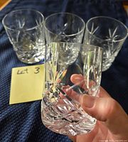 All four crystal whiskey glasses with close-up of pattern