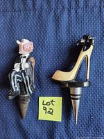 Front view of both bottle stoppers showing designs and condition