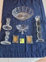 Entire lot: two glass bowls, three candlesticks, two metal frames