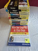 Stack of nine softcover books showing titles and spines