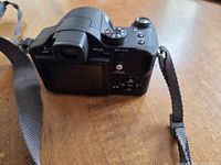 Rear view showing controls, screen, eyepiece and attached strap