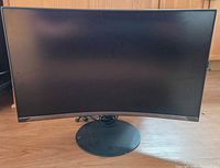Front view of black curved Samsung monitor on circular stand