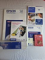 All six open photo paper packages displayed