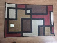 Full view of rectangular geometric rug on wood floor