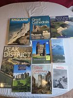 All nine books laid out on surface showing covers