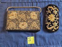 Front view of embroidered velvet handbag and matching eyeglass case