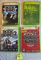 Front view of four Xbox 360 Rock Band series game cases