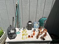 Overview of all items on table outdoors against wall showing full lot contents