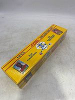 Yellow rectangular box of 1990 Score Baseball Collector Set with 714 player cards, still sealed in original shrink wrap.