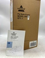 Original cardboard box labeled Bissell Pet Stain Eraser Model 2003T with user guide placed in front.