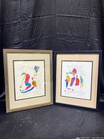 Two framed colorful art prints by Brian Andreas showing abstract figures with poetic handwritten text, side by side.