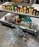 Image showing the entire set of Christmas-themed items including block letters, Santa cookie jar, holiday plates, books, blue reindeer and various ornaments.