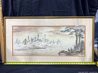 Full view of framed watercolor painting with measurement rulers showing 21x40 inches approximate size