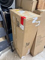Boxes of Costway folding chairs stacked vertically, showing packaging for new items
