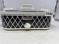 Front view of crockpot showing black and white geometric pattern and control dial.
