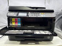 Front view of Epson WF-4630 printer showing open ink cartridge access door revealing black, yellow, magenta and cyan cartridges.