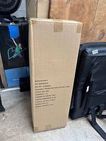 Cardboard box of the chair showing brand, item number, description, color, country of origin, and carton dimensions.