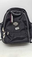 Front view of the black Harley-Davidson backpack where the logo and zippers are visible.