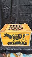Front view of wooden crate showing Hershey's Milk Chocolate cow graphic and checkerboard top.