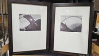 Two framed black and white photos of bridges by Lennart Olson shown side by side