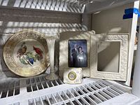Full lot showing 5 items: bird plate, vase, clock, and two frames (one without back).
