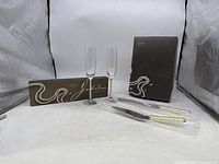 Full lot with two crystal toasting flutes and boxed cake knife and dessert server with pearl detail handles.