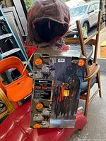 Pre-lit Grim Reaper decoration with box and displayed figure showing hooded head and tattered cloth.