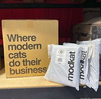 Photo showing the Modkat XL litter box box and three packages of liners