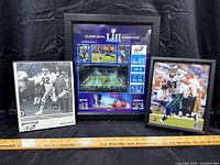 Framed Mike Quick signed black and white photo and Nick Muse signed color photo with Super Bowl LII Champions poster in the center