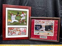Two framed Philadelphia Phillies posters side-by-side on black backdrop showing World Series celebration and Mike Schmidt action shot with plaque.