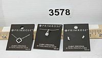 Three pieces of Primrose sterling silver cubic zirconia jewelry on display cards with price tags visible.