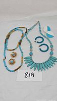 All jewelry pieces displayed together on a white background with lot number 819