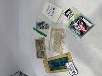 Overview of the entire lot showing currency, stamps, postcards, transit booklet, and documents spread on a white surface.